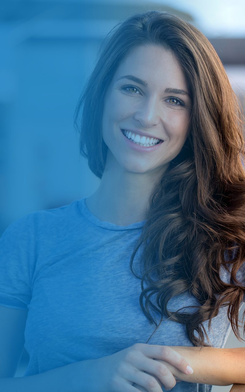 Smiling woman in blue shirt with long hair